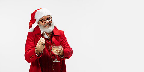 Image showing Modern stylish Santa Claus in red fashionable suit isolated on white background