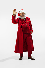 Image showing Modern stylish Santa Claus in red fashionable suit isolated on white background