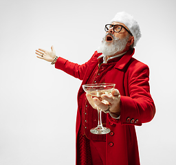 Image showing Modern stylish Santa Claus in red fashionable suit isolated on white background