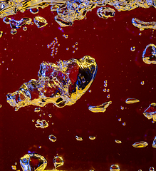 Image showing Close up view of the cold and fresh cola with bright bubbles in neon light