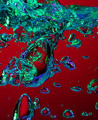 Image showing Close up view of the cold and fresh cola with bright bubbles in neon light