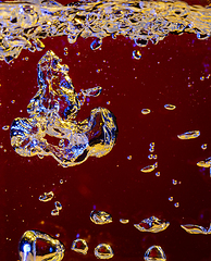 Image showing Close up view of the cold and fresh cola with bright bubbles in neon light