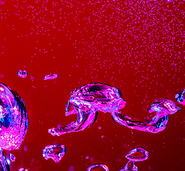 Image showing Close up view of the cold and fresh cola with bright bubbles in neon light