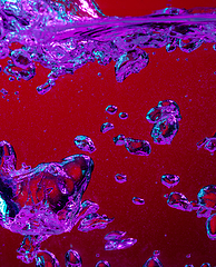 Image showing Close up view of the cold and fresh cola with bright bubbles in neon light