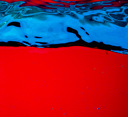 Image showing Close up view of the cold and fresh cola with bright bubbles in neon light