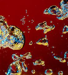 Image showing Close up view of the cold and fresh cola with bright bubbles in neon light