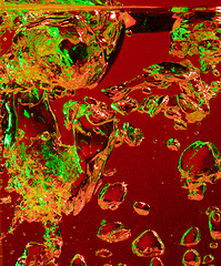 Image showing Close up view of the cold and fresh cola with bright bubbles in neon light