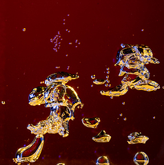 Image showing Close up view of the cold and fresh cola with bright bubbles in neon light