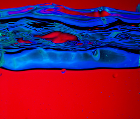 Image showing Close up view of the cold and fresh cola with bright bubbles in neon light