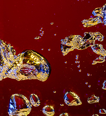 Image showing Close up view of the cold and fresh cola with bright bubbles in neon light