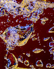 Image showing Close up view of the cold and fresh cola with bright bubbles in neon light