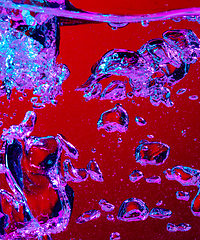 Image showing Close up view of the cold and fresh cola with bright bubbles in neon light