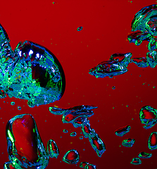 Image showing Close up view of the cold and fresh cola with bright bubbles in neon light