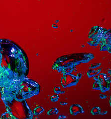 Image showing Close up view of the cold and fresh cola with bright bubbles in neon light