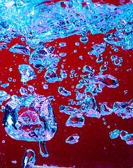 Image showing Close up view of the cold and fresh cola with bright bubbles in neon light