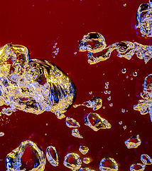 Image showing Close up view of the cold and fresh cola with bright bubbles in neon light