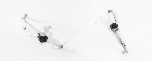 Image showing Teen girl in fencing costume with sword in hand isolated on white background, top view