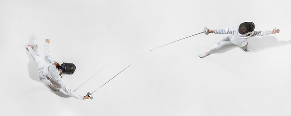 Image showing Teen girl in fencing costume with sword in hand isolated on white background, top view