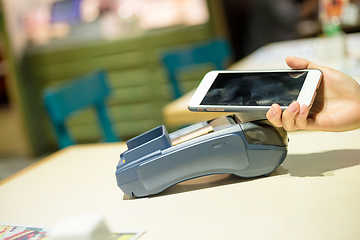 Image showing Customer pay the bill with cellphone