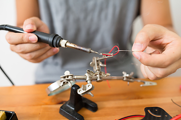 Image showing Man welding parts on drone body