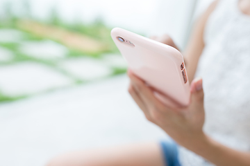 Image showing Woman sending sms on mobile phone