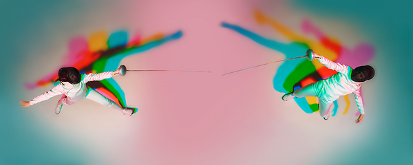 Image showing Teen girl in fencing costume with sword in hand on gradient background with neon light, top view