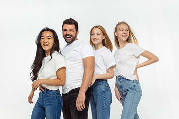 Image showing Group of adorable multiethnic friends having fun isolated over white studio background