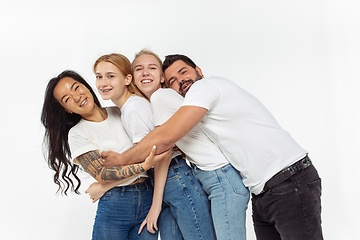 Image showing Group of adorable multiethnic friends having fun isolated over white studio background