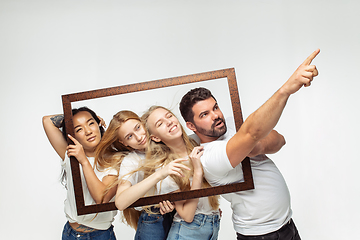 Image showing Group of adorable multiethnic friends having fun isolated over white studio background