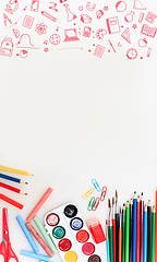 Image showing Colorful school supplies corner border over a white background with negative space