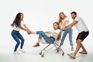 Image showing Group of adorable multiethnic friends having fun isolated over white studio background