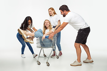 Image showing Group of adorable multiethnic friends having fun isolated over white studio background