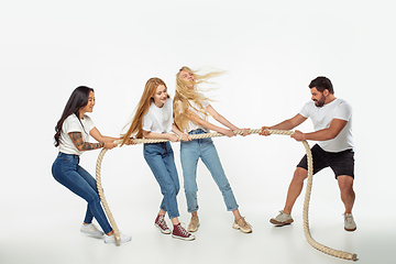Image showing Group of adorable multiethnic friends having fun isolated over white studio background