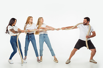 Image showing Group of adorable multiethnic friends having fun isolated over white studio background