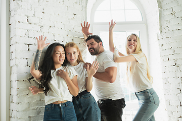 Image showing Group of adorable multiethnic friends having fun at home interior background