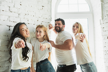 Image showing Group of adorable multiethnic friends having fun at home interior background