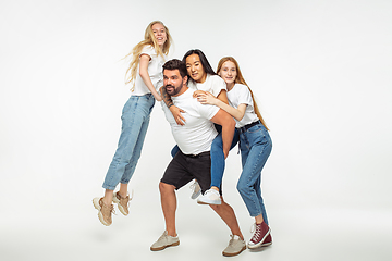 Image showing Group of adorable multiethnic friends having fun isolated over white studio background