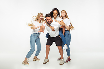 Image showing Group of adorable multiethnic friends having fun isolated over white studio background