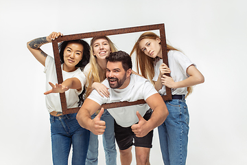 Image showing Group of adorable multiethnic friends having fun isolated over white studio background