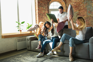 Image showing Group of adorable multiethnic friends having fun at home interior background