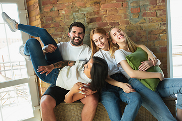 Image showing Group of adorable multiethnic friends having fun at home interior background