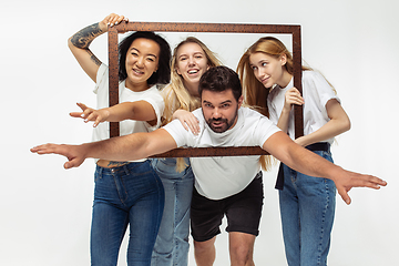 Image showing Group of adorable multiethnic friends having fun isolated over white studio background