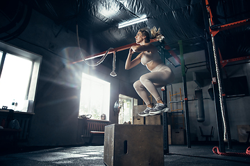 Image showing The female athlete training hard in the gym. Fitness and healthy life concept.