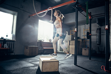 Image showing The female athlete training hard in the gym. Fitness and healthy life concept.