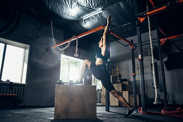 Image showing The female athlete training hard in the gym. Fitness and healthy life concept.