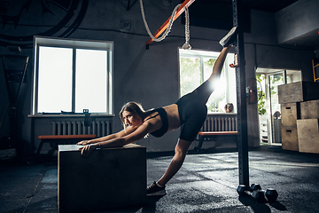 Image showing The female athlete training hard in the gym. Fitness and healthy life concept.