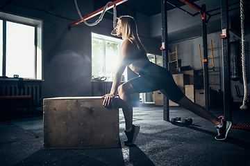 Image showing The female athlete training hard in the gym. Fitness and healthy life concept.