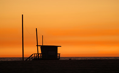 Image showing A lifeguard shack on a beach against a golden sunset