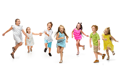 Image showing Happy little caucasian kids jumping and running isolated on white background