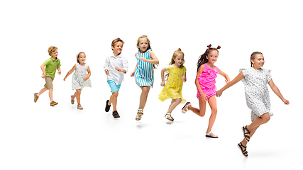 Image showing Happy little caucasian kids jumping and running isolated on white background